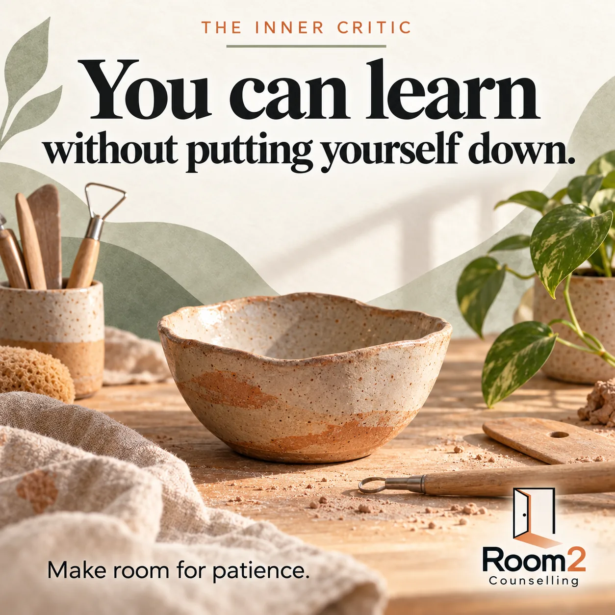 An uneven handmade ceramic bowl stands on a sunlit pottery workbench, with clay tools and a green plant. Text: The inner critic. You can learn without putting yourself down. Make room for patience. Room2 Counselling logo at the bottom right.